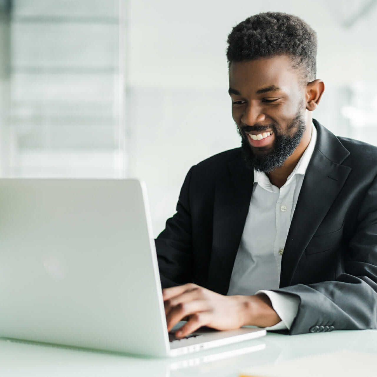 thoughtful-african-american-businessman-using-laptop-pondering-project-business-strategy-puzzled-employee-executive-looking-laptop-screen-reading-email-making-decision-office